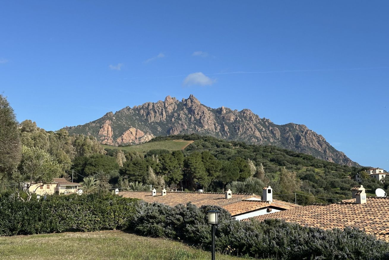 A mountainous landscape with terraced houses and a clear sky.