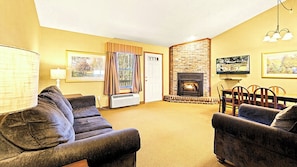 A cozy living room with a fireplace, comfortable seating, and artwork on the walls. - Mountain Views, Waterfall Wanders & Wallet-Friendly Escapes (Lake Harmony)