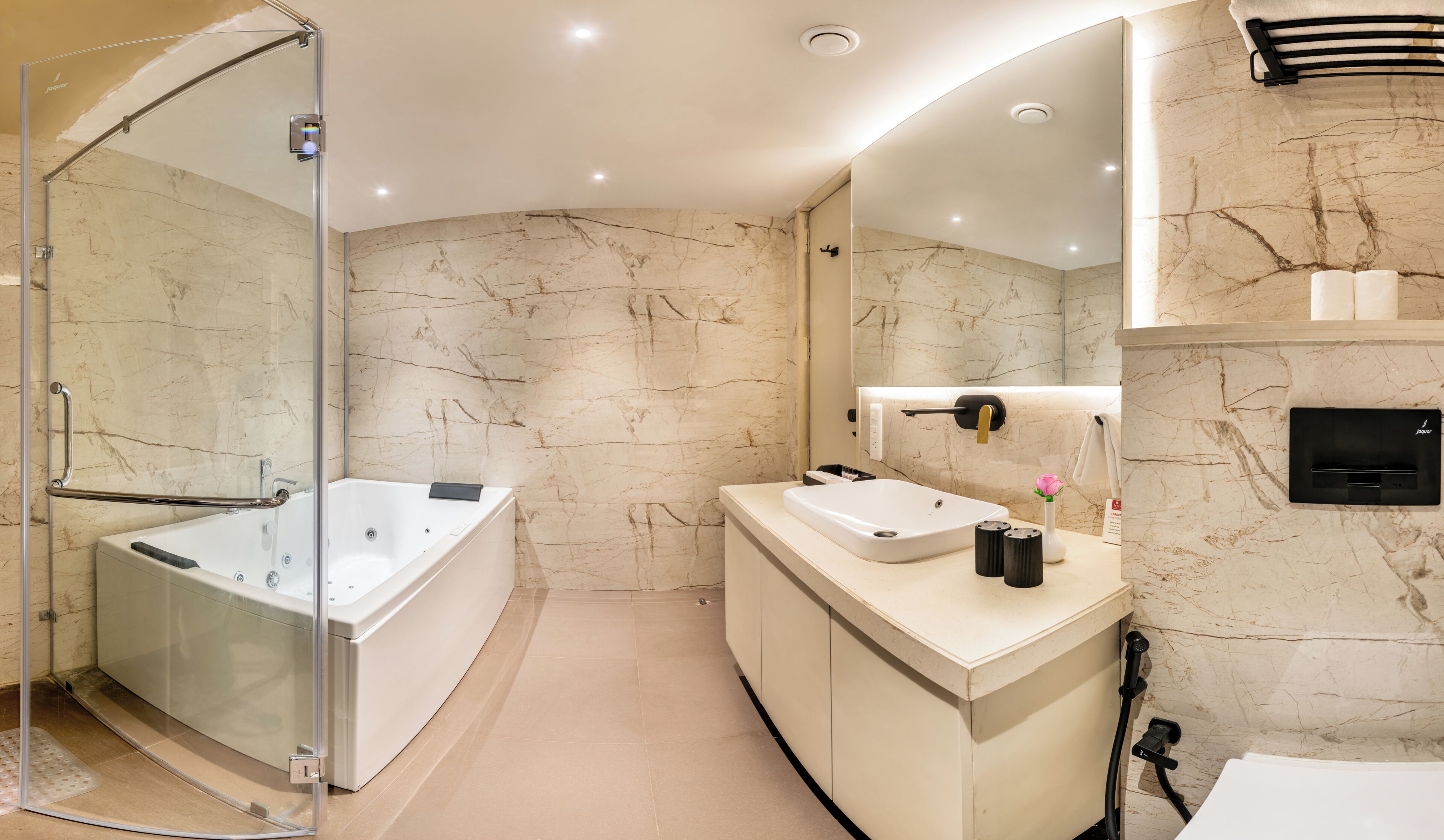 A modern bathroom with a glass-enclosed shower, a freestanding bathtub, and a vanity with a sink and mirror.