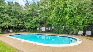 A swimming pool surrounded by a fence, with trees in the background. - Denton pad with 2BR comfort (Denton)