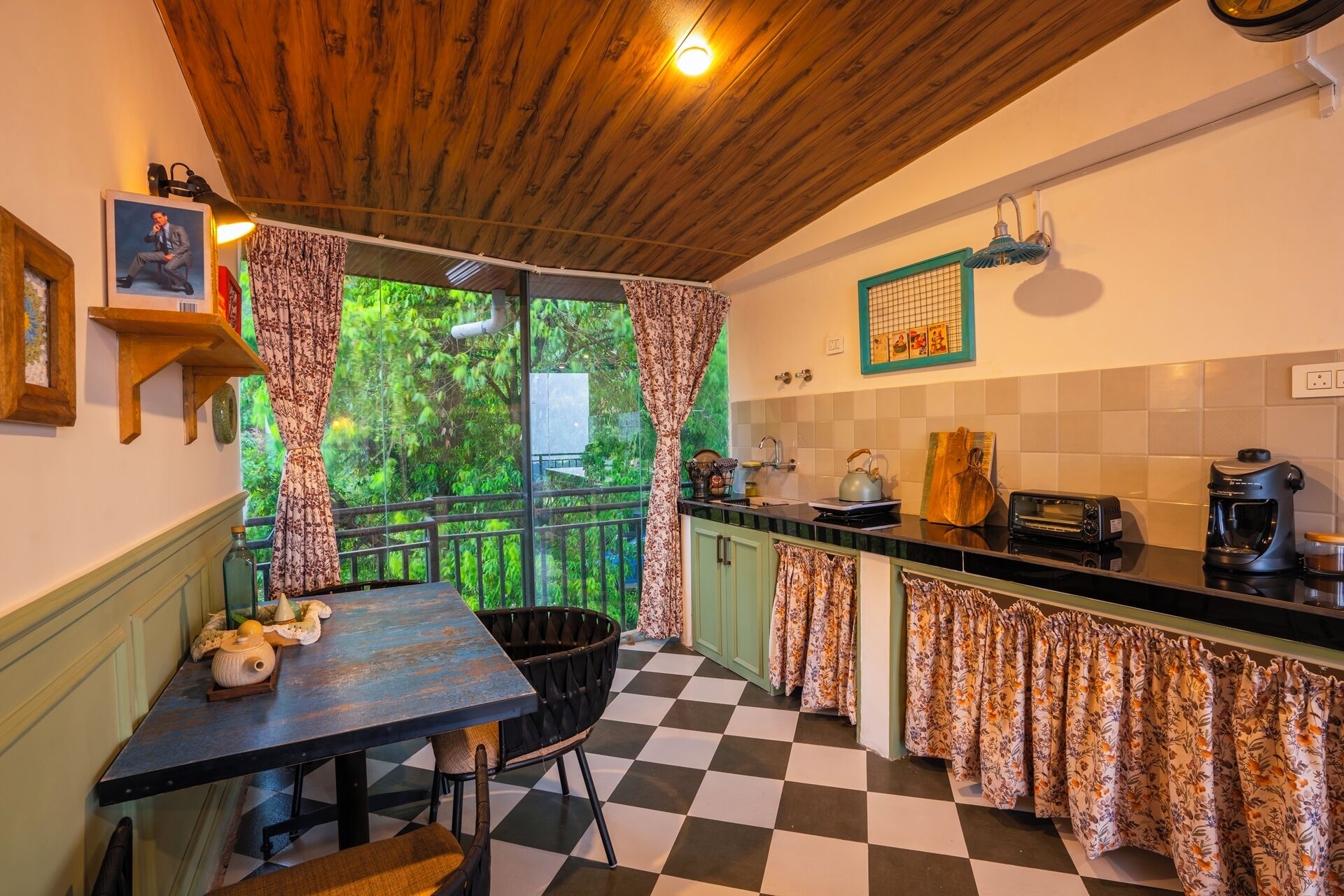 A compact kitchen with a checkered floor, a dining table with chairs, a coffee machine, and a toaster.
