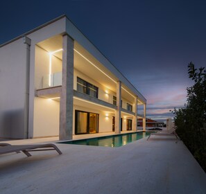 A modern multi-story house with a swimming pool, large windows, and a balcony. - Villa Turnea With Heated Pool (Sveti Filip i Jakov)