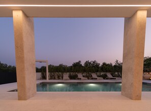 A modern outdoor pool area with a clear view of the sky, surrounded by concrete pillars and equipped with lounge chairs. - Villa Turnea With Heated Pool (Sveti Filip i Jakov)