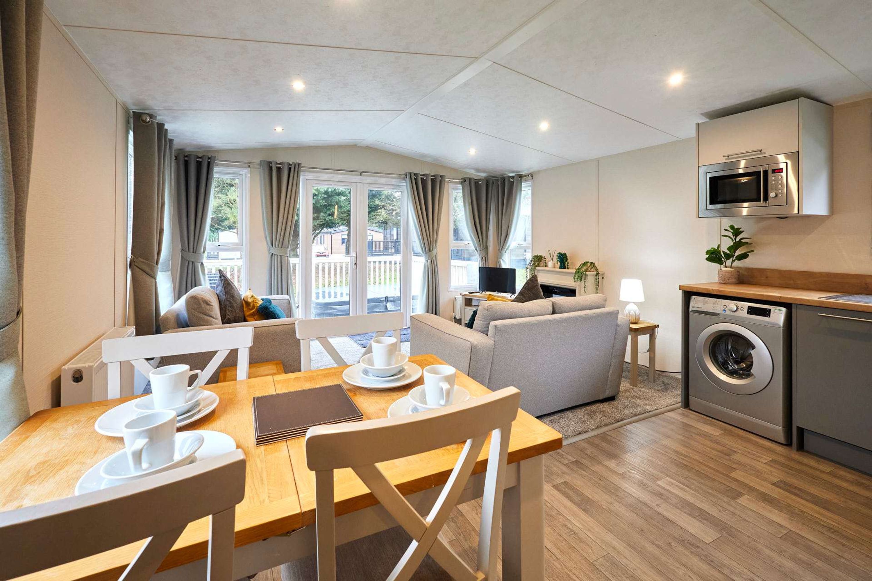 A modern apartment with a dining area, living room, and kitchen.