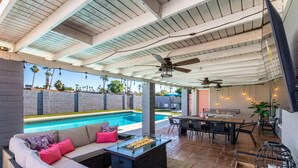 An outdoor patio with a pool, seating area, and a grill. - NEW - The Desert Bloomhouse With Heated Pool (Scottsdale)