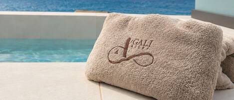 A towel with a logo on a poolside.