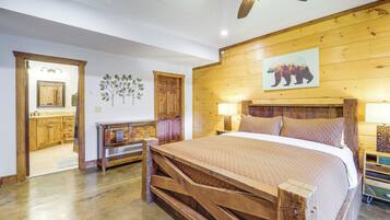 A bedroom with a wooden bed frame, a ceiling fan, a wooden wall panel, and a bear painting.