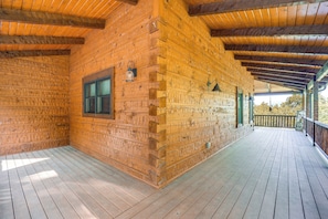 A wooden cabin with a covered porch and a window. - Game Room + Deck: Spacious Spruce Pine Retreat! (Spruce Pine)