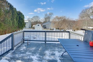 A covered outdoor deck with a metal railing, a bench, and a table. - 1 Mi to Head's Beach! Nautical Family Retreat (Jamestown)