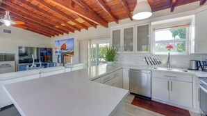 A modern kitchen with white cabinets, stainless steel appliances, and a large island. - Oakland Park Gem w/ Year-round Pool, 4 Mi to Beach (Fort Lauderdale)