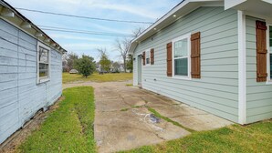 A two-story house with a front yard and a driveway. - Fully Updated & Convenient! Baytown Home Near Dtwn (Baytown)