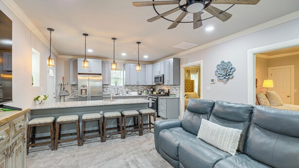 A modern kitchen with a central island, bar stools, and pendant lighting. - Fully Updated & Convenient! Baytown Home Near Dtwn (Baytown)