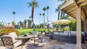 An outdoor patio with a wicker sofa, chairs, and a table. - 11 Mi to Coachella: Palm Desert Gem w/ Pool Access (Palm Desert)