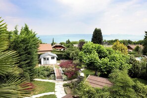 A residential area with houses, a pathway, and a view of a body of water.