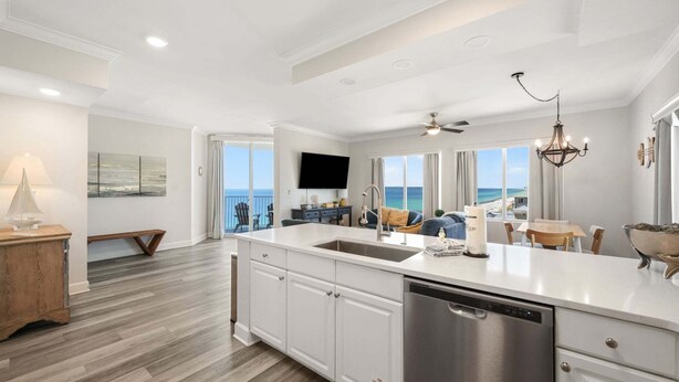 A modern kitchen with a large island, a dishwasher, and a view of the ocean. - TW 1600-King Bed-Arcade-Sauna-New Listing (Panama City Beach)