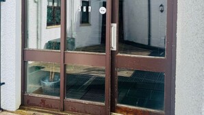 A brown glass door with a number '567' and a handle.