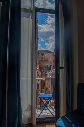 Ein Zimmer mit Blick auf Gebäude durch eine Glastür.