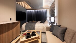 A hotel room with a bed, a sofa, a desk with a tray of items, and a TV. - HOTEL ZEN narahourai (Nara)