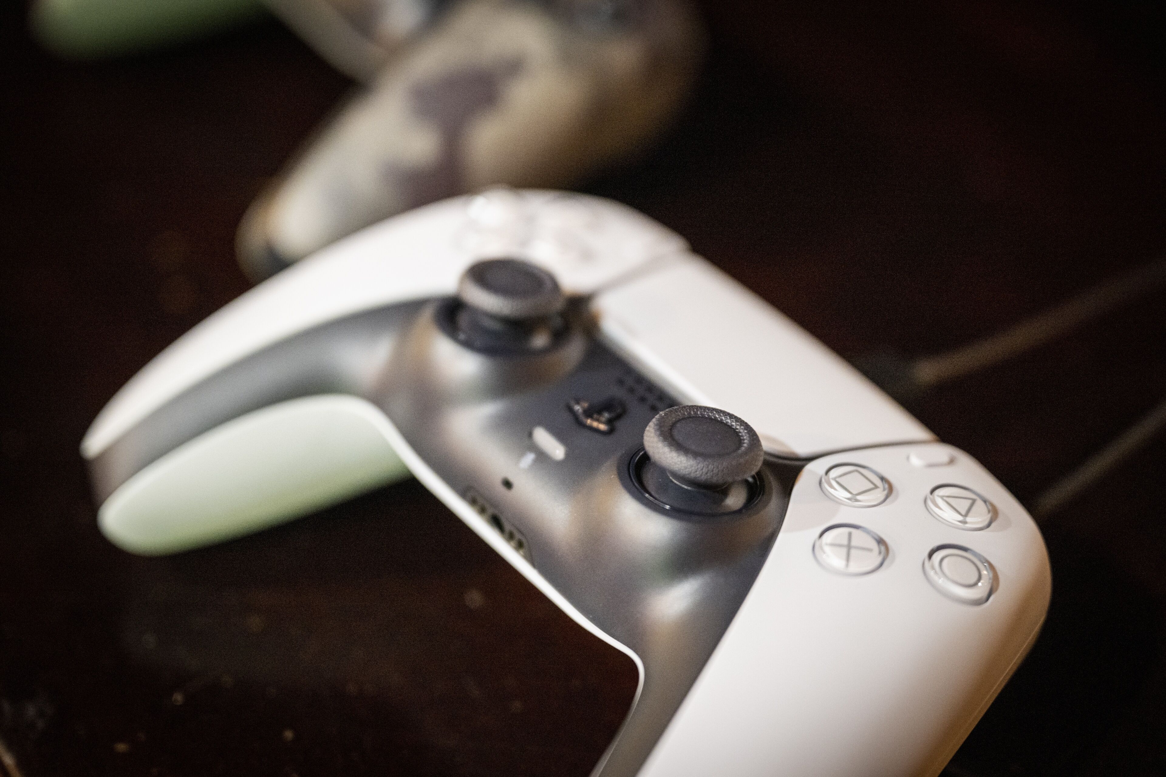 A close-up of a gaming controller with a textured grip and directional buttons.