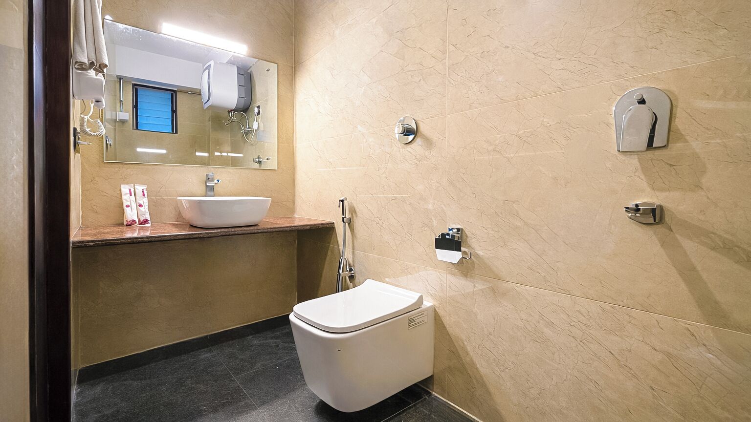 A modern bathroom with a white sink, a toilet, and a shower.