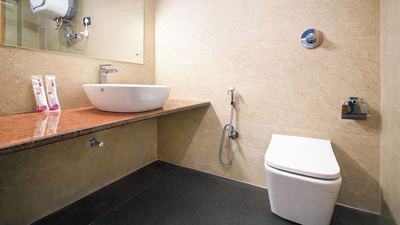 A modern bathroom with a white sink, a toilet, and a shower.