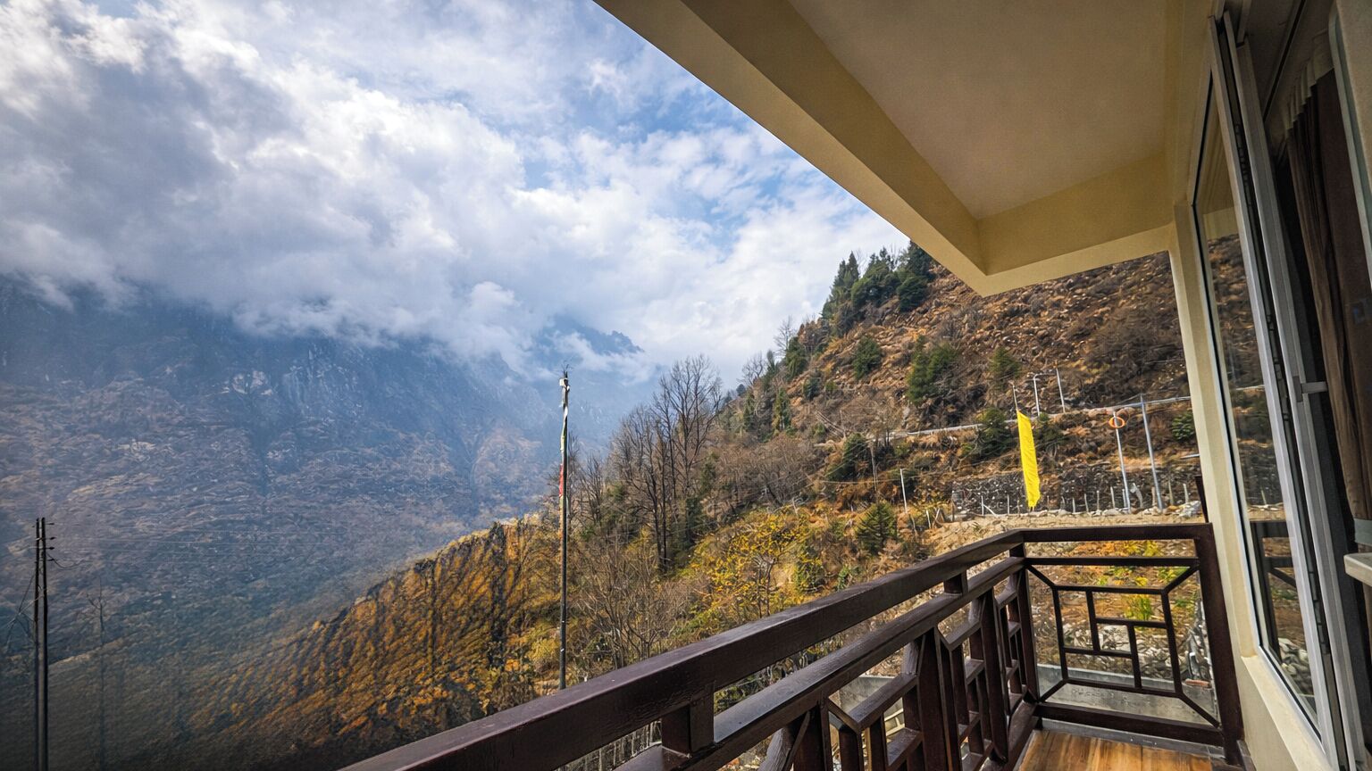 A balcony with a view of a mountainous landscape.