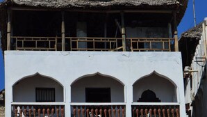 A building with a sign for Lamu Archipelago Villa Hotel and National Bank. - Lamu Archipelago Villa Hotel (Lamu)