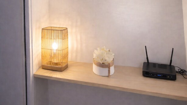 A shelf with the word "PARIS" on it, a lit candle, and a small decorative item. - Magic Stay Val d' Europe (Chessy)