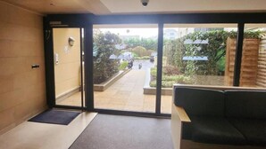 A modern interior with a sliding glass door leading to a courtyard. - Magic Stay Val d' Europe (Chessy)