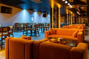 A hotel lobby with orange seating, a bar area, and a dining section. - Barida Hotels Davraz (Isparta)