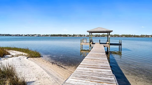 A wooden dock leading to a gazebo with benches, surrounded by calm water and a distant shoreline. - Lagoon-front Duplex w/Fishing Pier Sleeps 24/BM (Gulf Shores)