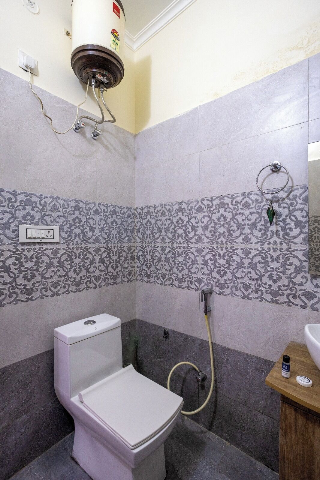 A bathroom with a toilet, a shower, and a sink.