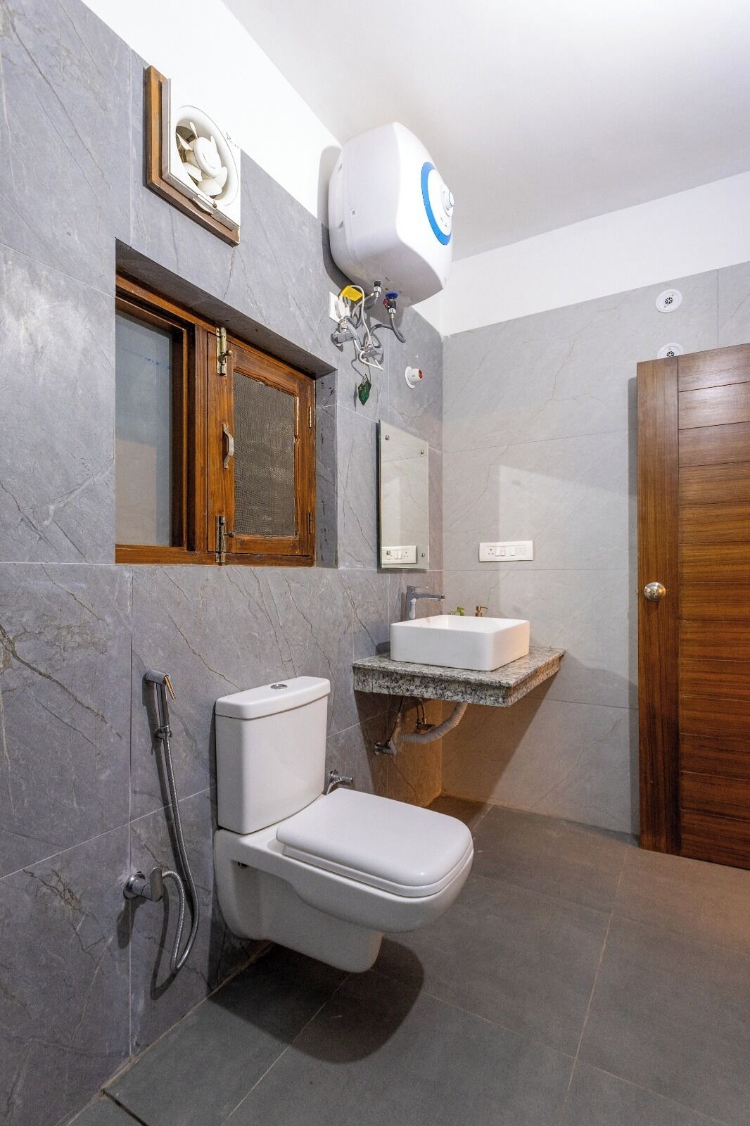 A bathroom with a toilet, a sink, and a shower.