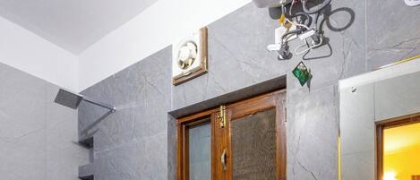 A modern bathroom with a toilet, shower, and sink.
