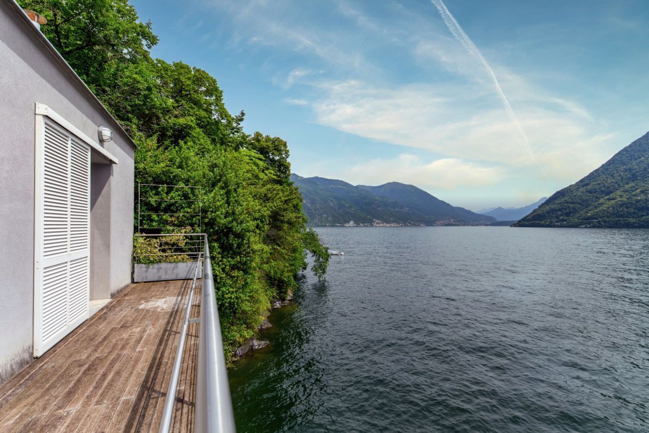 A balcony with a view of a lake and mountains.