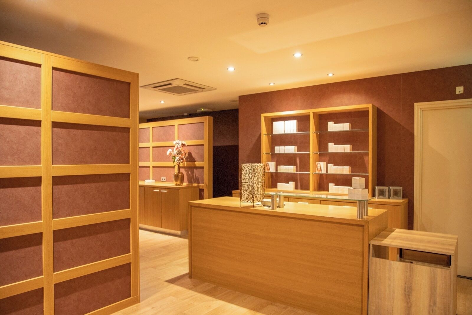 A jewelry store interior with wooden display cases and a central counter.
