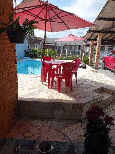 Beach retreat with pool, barbecue, and pool table.