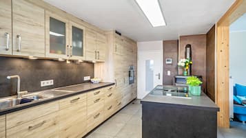 Una cucina moderna con mobili in legno, elettrodomestici in acciaio inossidabile e un'isola centrale.