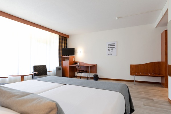 Recharge in a spacious room with desk and TV corner.