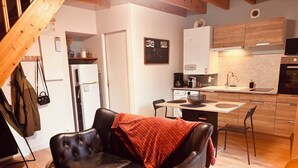 A modern kitchen with wooden cabinets, a built-in oven, and a coffee machine. - House 4/5 persons near Puy du Fou (Nueil-les-Aubiers)