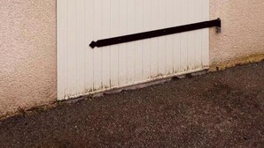 A white door with three black horizontal bars, a number '7' sign, and a small Airbnb sign on the wall. - House 4/5 persons near Puy du Fou (Nueil-les-Aubiers)