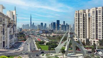 A cityscape with modern architecture, a prominent bridge, and a skyline with high-rise buildings.