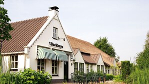 A traditional building with a sign reading "tBackhuis" and a green awning.