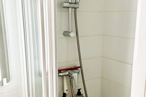 A shower with a handheld showerhead, a wall-mounted faucet, and a handheld hose. - Romantic Mountain Stay in Mont-Dore (Mont-Dore)