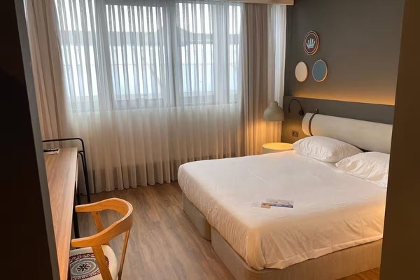 Wake up refreshed beside soft light and airy curtains.