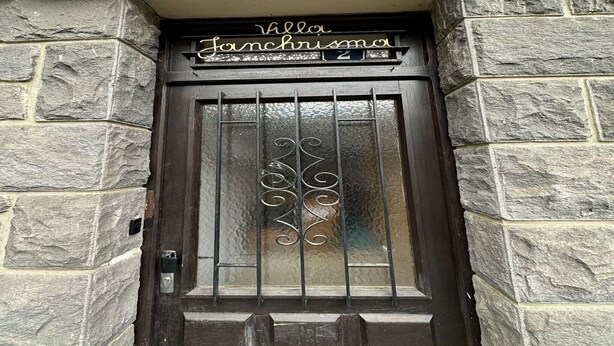A stone building entrance with a dark wooden door, a metal gate, and a sign above the door that reads "Villa Janchrisma." - Spacious Family Stayin Mont-Dore (Mont-Dore)