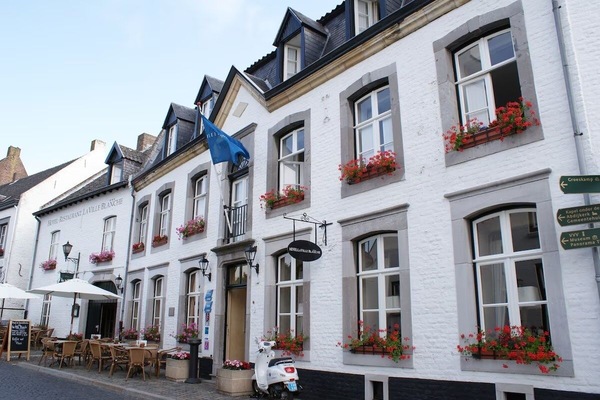 Arrive to charming flowered facade in a storybook street.