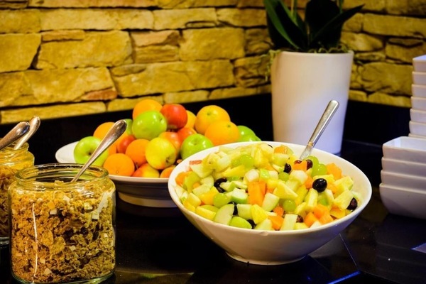 Savor colorful fresh fruit and crisp granola for breakfast.
