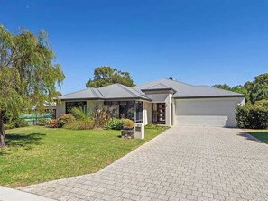 A two-story house with a paved driveway and a garage. - Ile-de-Re: Generous Garden Home by the Beach (Dunsborough)