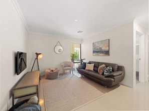 A modern living room with a sofa, armchair, and a lamp. - Ile-de-Re: Generous Garden Home by the Beach (Dunsborough)